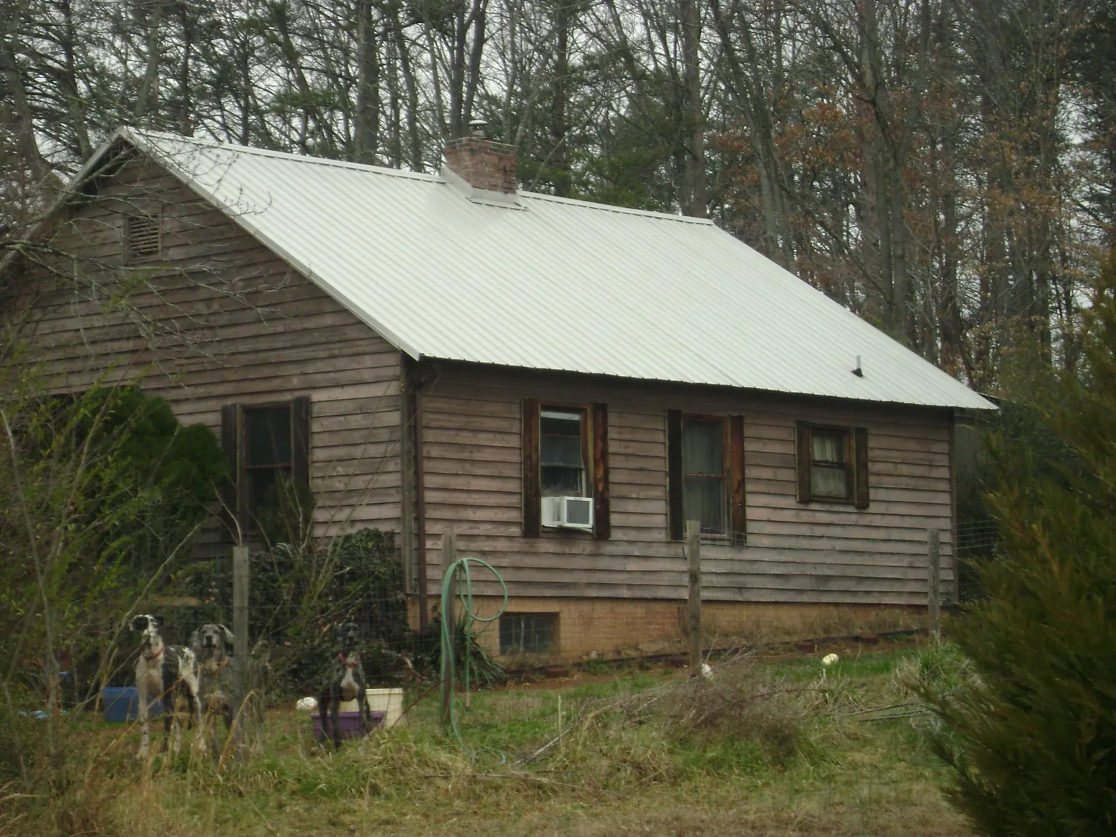 White metal roof on an old wood sided farmhouse, from a Metal Roof Installation job in Braithwaite
